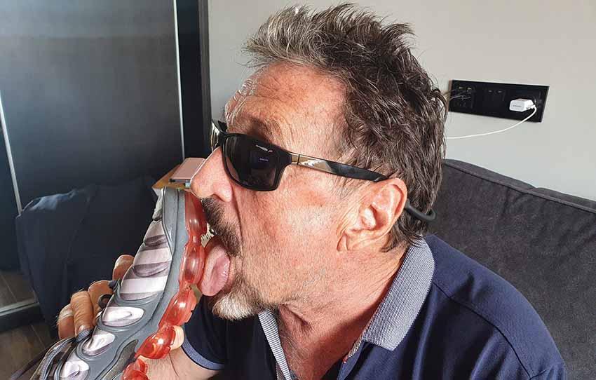 John McAfee challenges the coronavirus by licking the soles of his sneakers